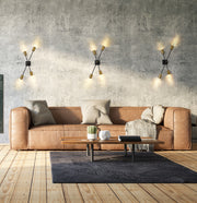 Calumet 4 Light 4.5" Wall Sconce in Matte Black + Olde Brass in a room setting