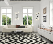 Calumet 4 Light 4.5" Wall Sconce in Matte Black + Polished Nickel in a room setting