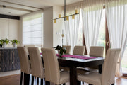 Calumet 5 Light 38" Linear Pendant in Matte Black + Olde Brass in a room setting