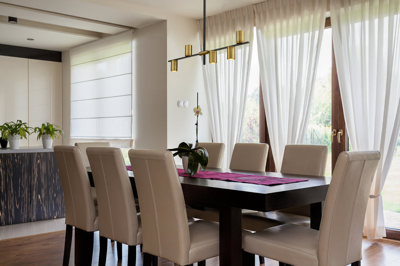 Calumet 5 Light 38" Linear Pendant in Matte Black + Olde Brass in a room setting