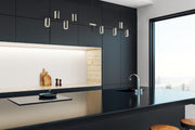 Calumet 8 Light 56" Linear Pendant in Matte Black + Polished Nickel in a room setting