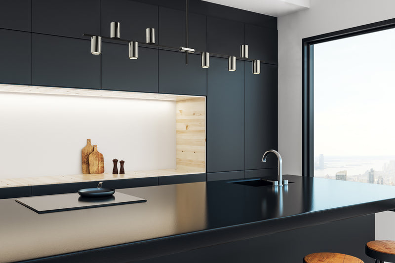 Calumet 8 Light 56" Linear Pendant in Matte Black + Polished Nickel in a room setting