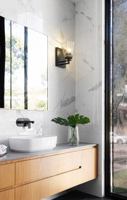 Lyna 1 Light 5" Wall Sconce in Matte Black in a room setting