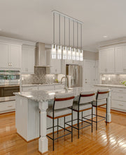 Alton 7 Light 54" Linear Pendant in Brushed Nickel in a room setting
