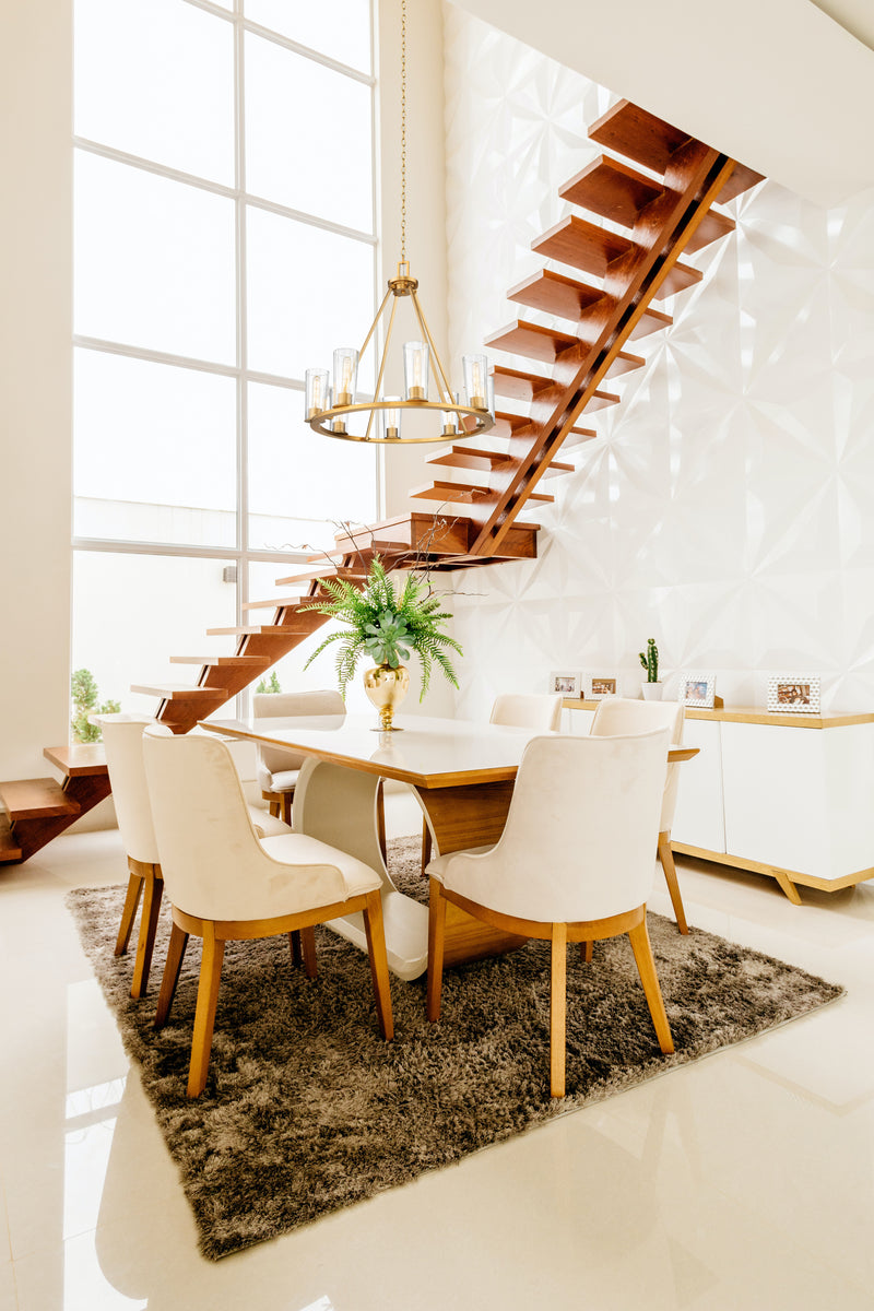 Titus 8 Light 33" Chandelier in Modern Gold in a room setting