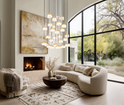 Renaud 27 Light 40.75" Pendant in Modern Gold in a room setting