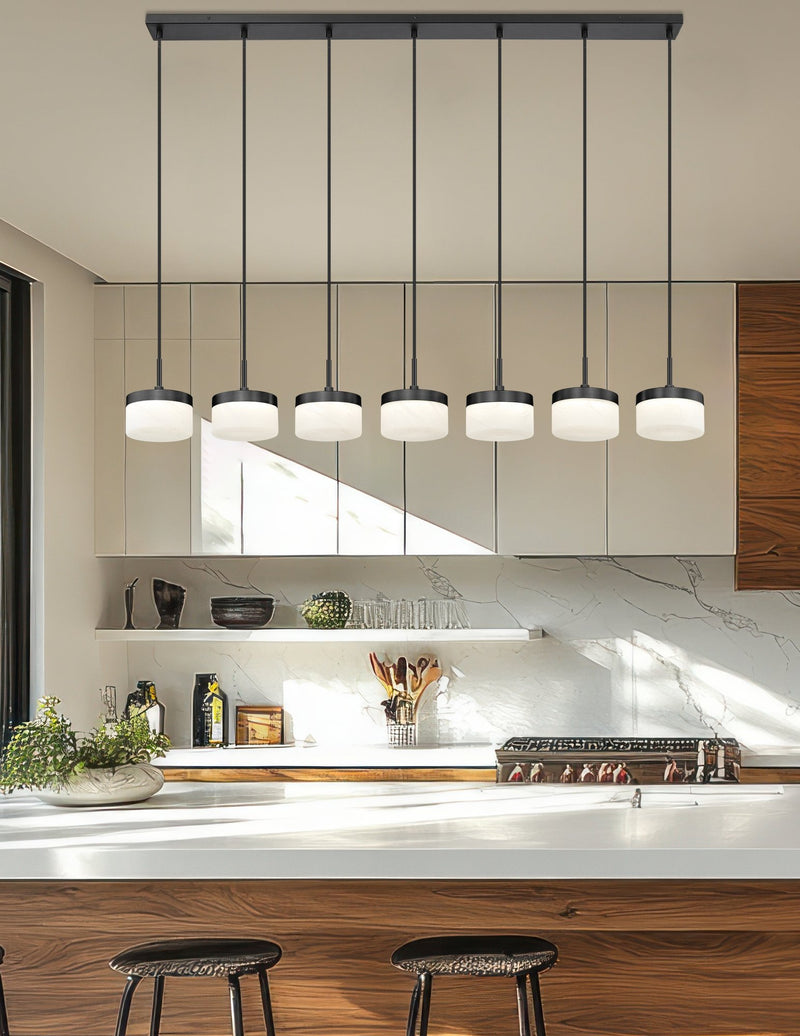 Renaud 7 Light 58.75" Linear Pendant in Matte Black in a room setting