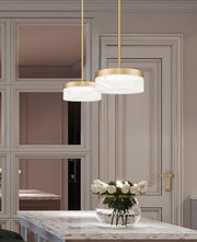Renaud 1 Light 9.25" Pendant in Modern Gold in a room setting