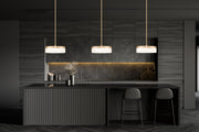 Renaud 1 Light 9.25" Pendant in Modern Gold in a room setting