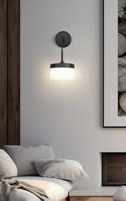 Renaud 1 Light 6.75" Wall Sconce in Matte Black in a room setting