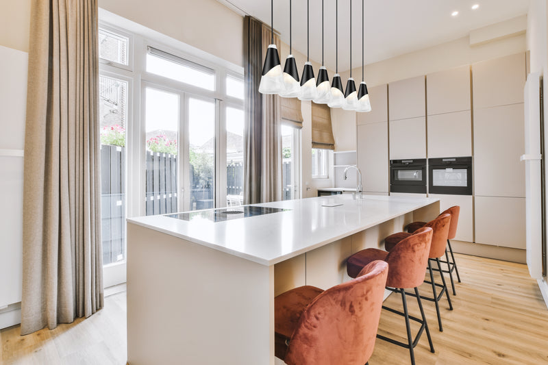 Aimie 7 Light 54" Linear Pendant, 13.25" Tall in Matte Black in a room setting