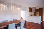 Forest 10 Light 56.5" Linear Pendant, 12" Tall in Chrome in a room setting