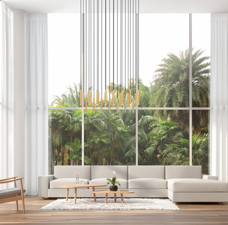 Forest 23 Light 54" Linear Pendant, 12" Tall in Modern Gold in a room setting