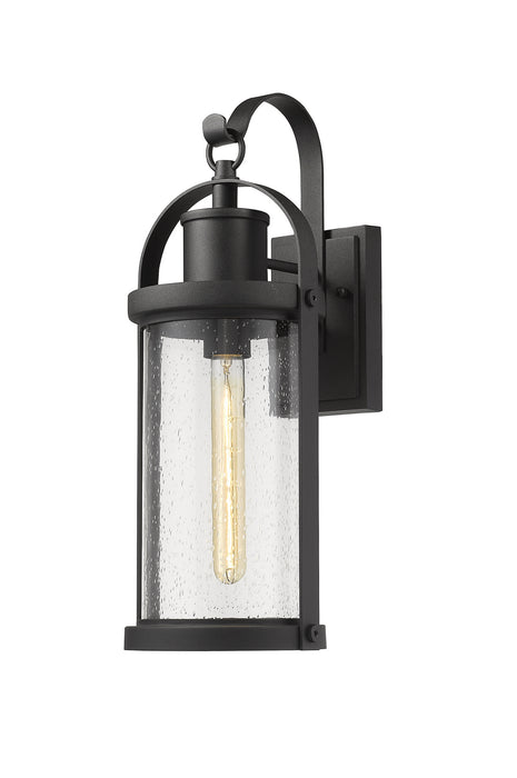 Roundhouse 1 Light Outdoor Wall Sconce in Black with Clear Seedy Glass