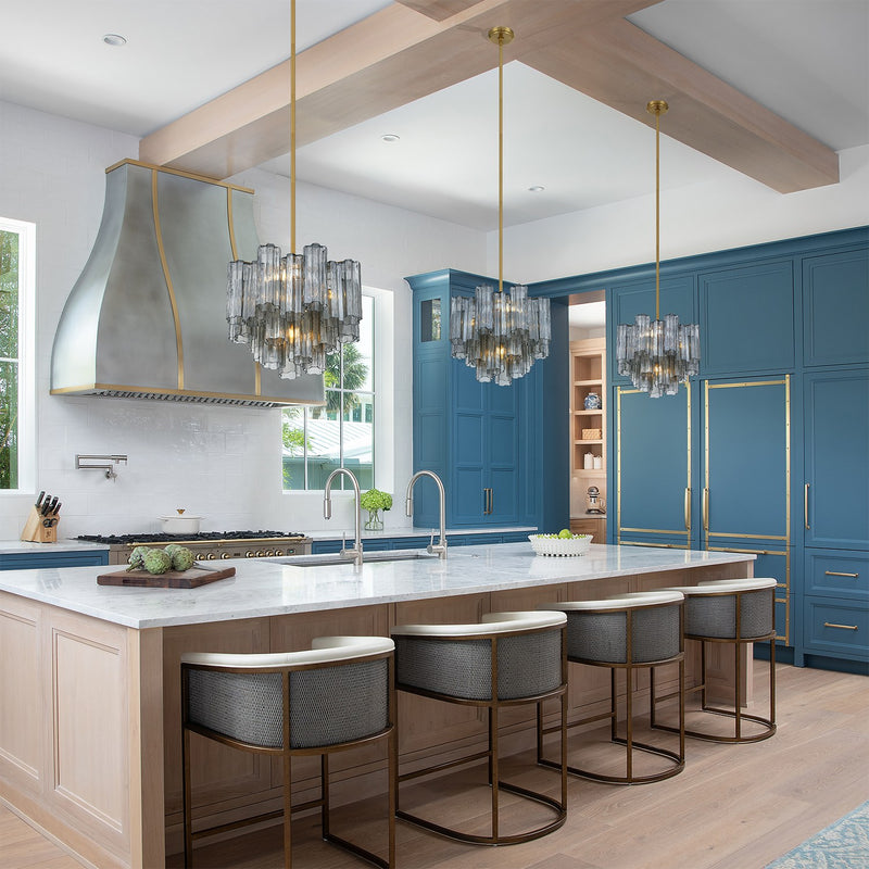 Addis 4 Light 17.75" Pendant in Aged Brass in a room setting