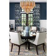 Addis 12 Light 26.75" Pendant in Aged Brass in a room setting