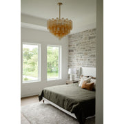 Addis 12 Light 26.75" Pendant in Aged Brass in a room setting