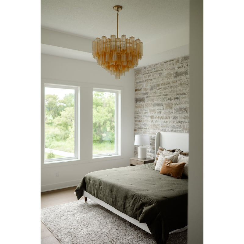 Addis 12 Light 26.75" Pendant in Aged Brass in a room setting