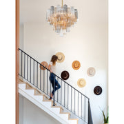 Addis 12 Light 26.75" Pendant in Aged Brass in a room setting