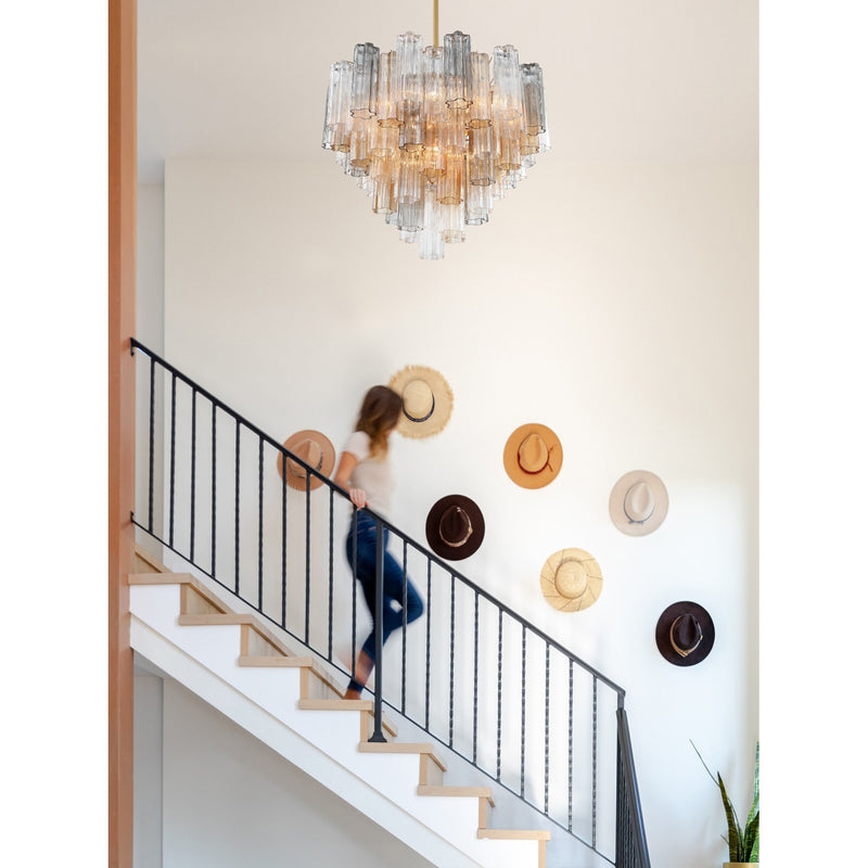 Addis 12 Light 26.75" Pendant in Aged Brass in a room setting