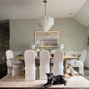 Addis 12 Light 26.75" Pendant in Aged Brass in a room setting
