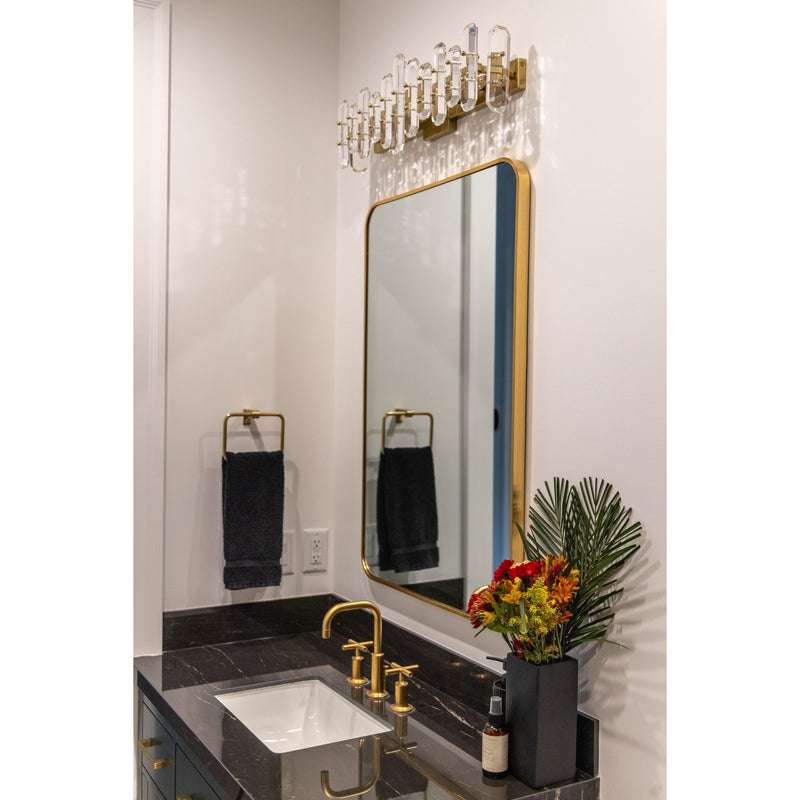 Bolton 3 Light 25.25" Bathroom Vanity in Aged Brass in a room setting