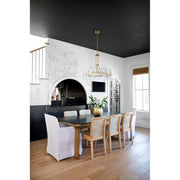 Bolton 12 Light 31" Chandelier in Aged Brass in a room setting