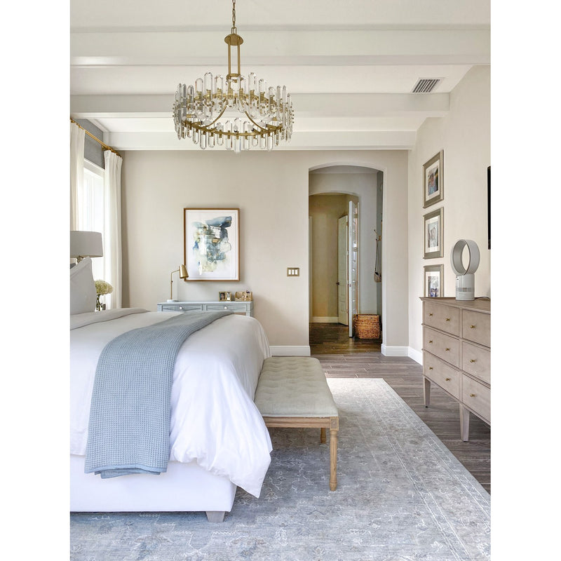Bolton 12 Light 31" Chandelier in Aged Brass in a room setting