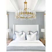 Bolton 12 Light 31" Chandelier in Aged Brass in a room setting