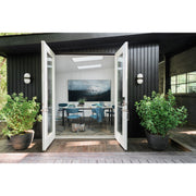 Capsule 1 Light 6" Outdoor Sconce in Matte Black + Textured Gold in a room setting