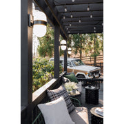 Capsule 2 Light 8" Outdoor Sconce in Matte Black + Textured Gold in a room setting
