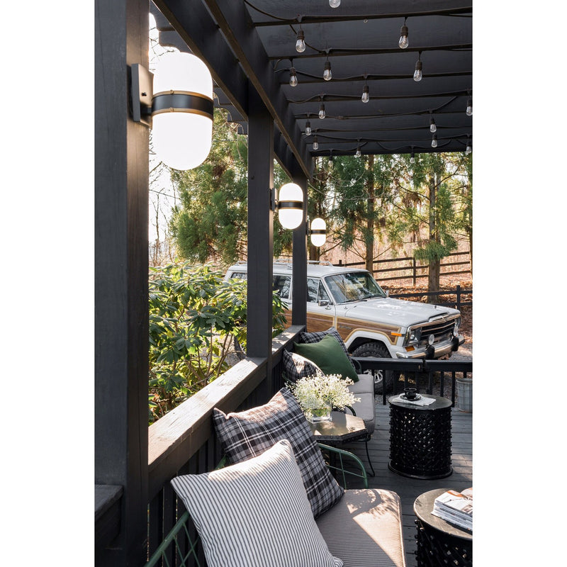 Capsule 2 Light 8" Outdoor Sconce in Matte Black + Textured Gold in a room setting