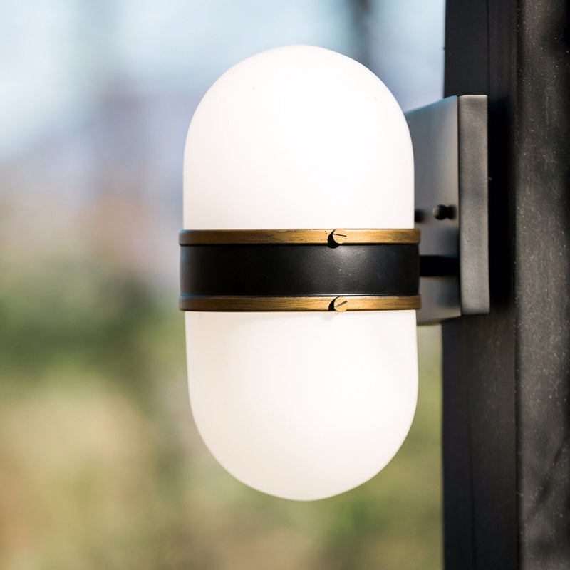 Capsule 2 Light 8" Outdoor Sconce in Matte Black + Textured Gold in a room setting