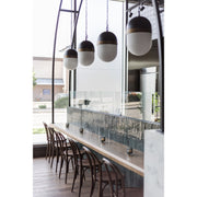 Capsule 3 Light 12.25" Outdoor Pendant in Matte Black + Textured Gold in a room setting