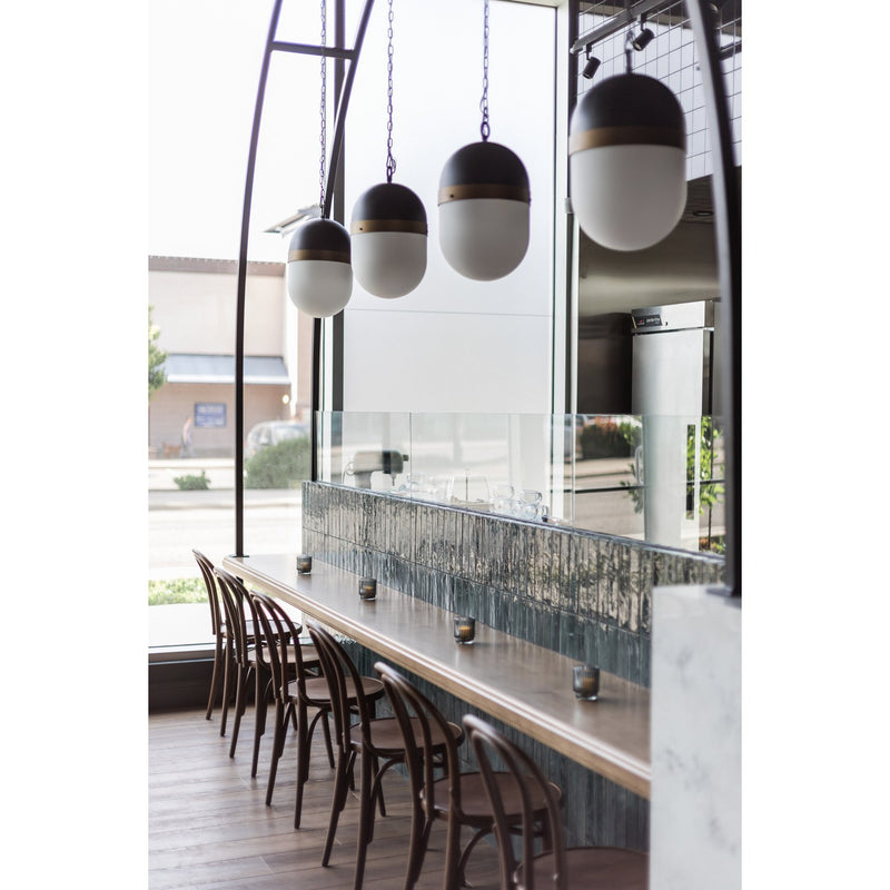 Capsule 3 Light 12.25" Outdoor Pendant in Matte Black + Textured Gold in a room setting
