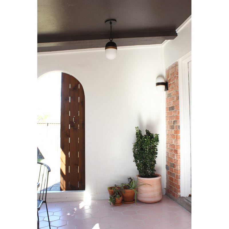 Capsule 3 Light 12.25" Outdoor Pendant in Matte Black + Textured Gold in a room setting