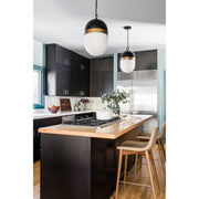 Capsule 1 Light 8" Outdoor Pendant in Matte Black + Textured Gold in a room setting