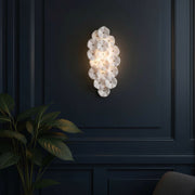 Esme 4 Light 23" Sconce in Aged Brass in a room setting