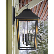 Hawkins 4 Light 15" Outdoor Sconce in Matte Black + Textured Gold in a room setting