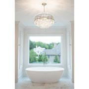 Hayes 12 Light 22" Pendant in Aged Brass in a room setting