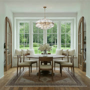 Hayes 16 Light 28" Pendant in Aged Brass in a room setting