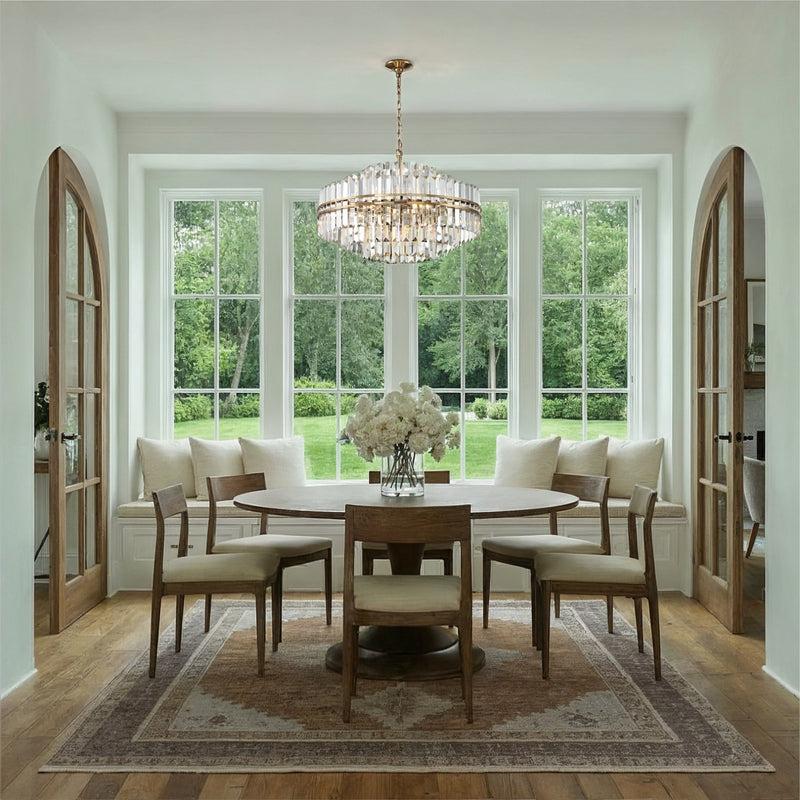 Hayes 16 Light 28" Pendant in Aged Brass in a room setting