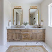 Hayes 4 Light 23.5" Bathroom Vanity in Aged Brass in a room setting