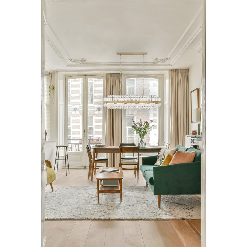 Hayes 16 Light 50" Linear Pendant in Aged Brass in a room setting