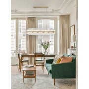 Hayes 16 Light 50" Linear Pendant in Aged Brass in a room setting