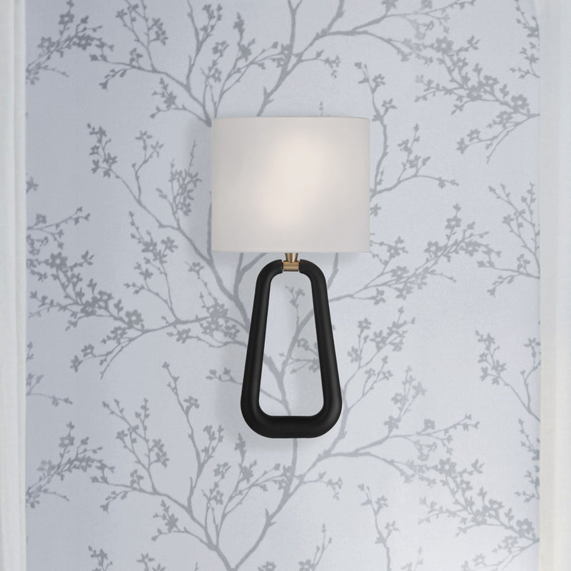 Jori 2 Light 10" Sconce in Aged Brass + Matte Black in a room setting
