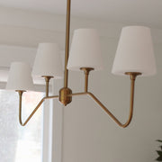 Keenan 4 Light 48" Linear Chandelier in Vibrant Gold in a room setting