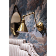 Morgan 1 Light 7" Task Sconce in Aged Brass in a room setting