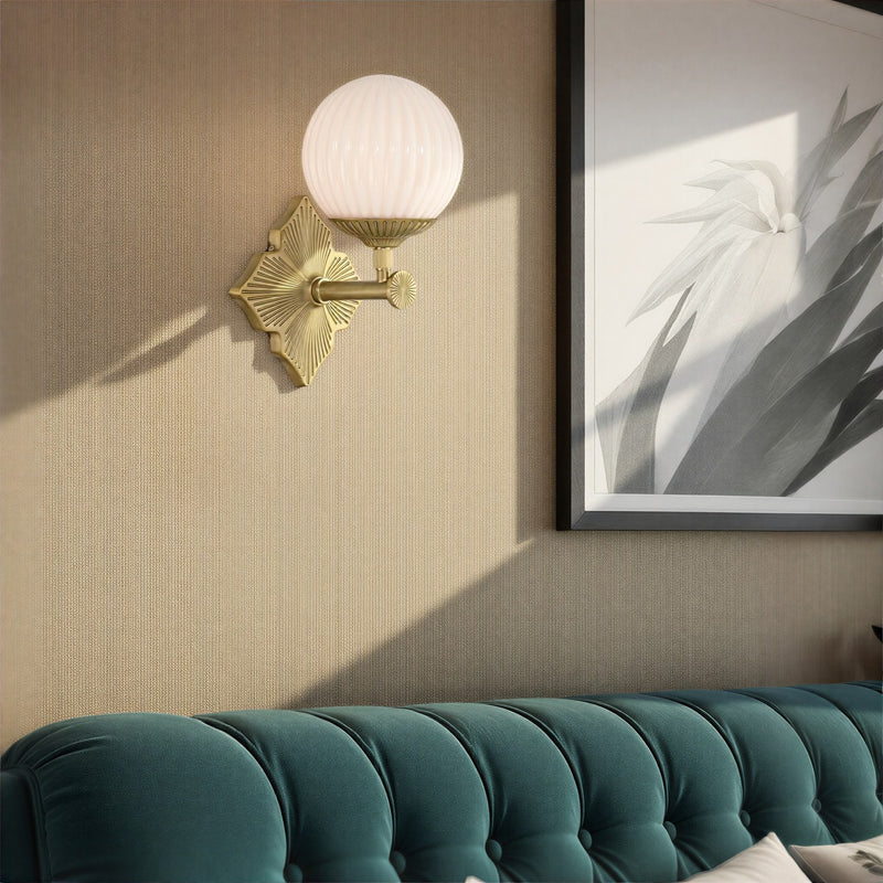 Orly 1 Light 7.5" Sconce in Aged Brass in a room setting