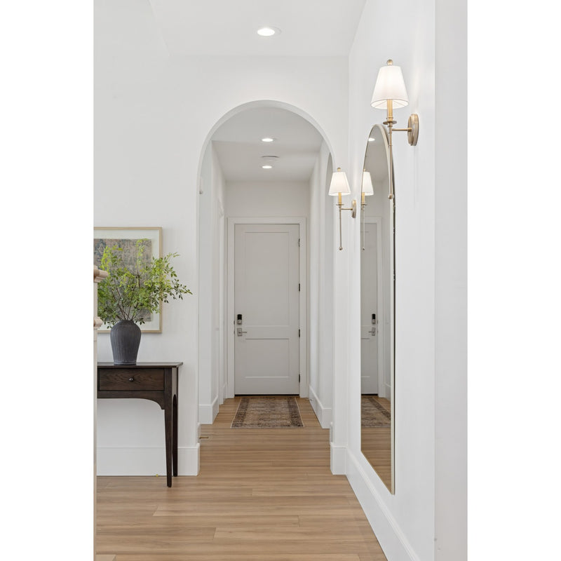 Riverdale 1 Light 6" Sconce in Aged Brass in a room setting